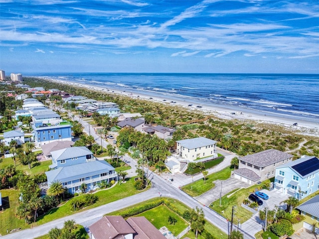 bird's eye view with a water view and a beach view