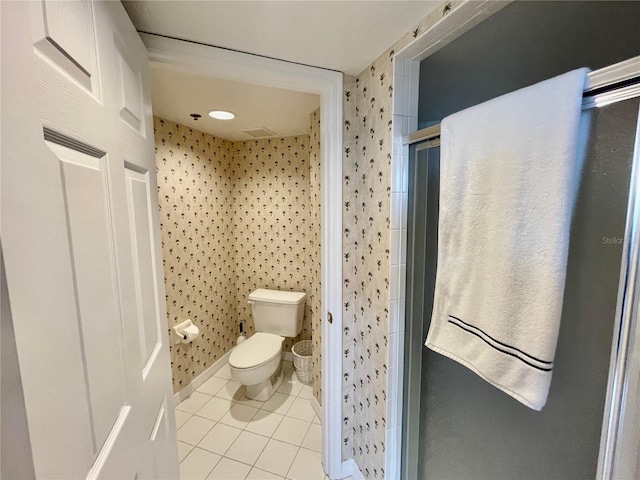 bathroom with walk in shower, toilet, and tile patterned flooring