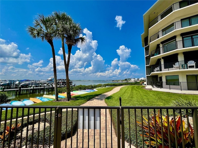 exterior space featuring a water view and a lawn