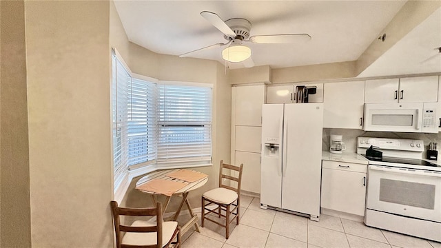 kitchen featuring white cabinetry, light tile patterned flooring, ceiling fan, and white appliances