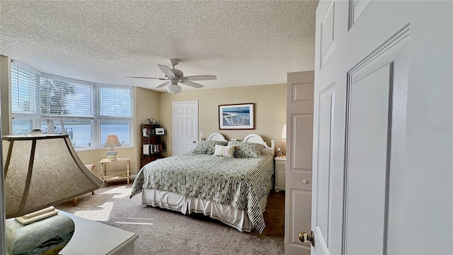 bedroom featuring a textured ceiling, ceiling fan, and carpet flooring