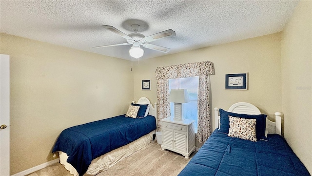 bedroom featuring light carpet, a textured ceiling, and ceiling fan