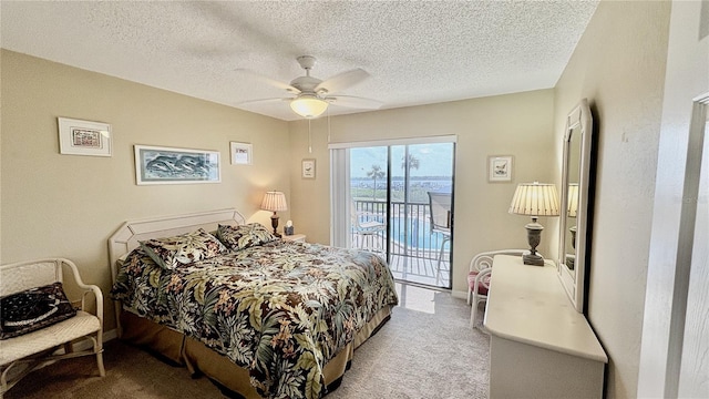 bedroom with ceiling fan, access to exterior, light carpet, and a textured ceiling