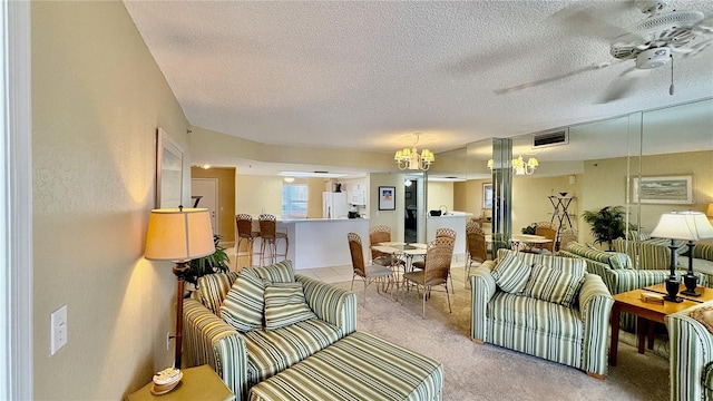 living room featuring ceiling fan, light colored carpet, and a textured ceiling