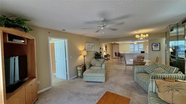 living room featuring ceiling fan with notable chandelier, light colored carpet, and a textured ceiling