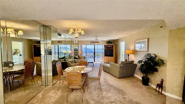 dining area with a notable chandelier, a textured ceiling, and carpet