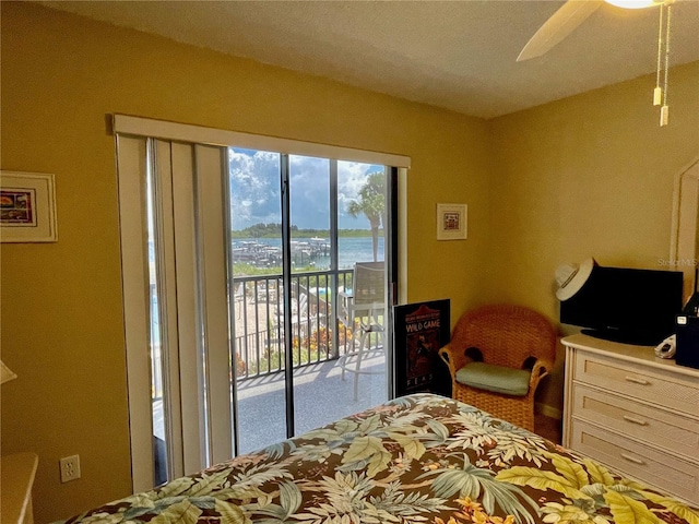 bedroom featuring ceiling fan and access to exterior