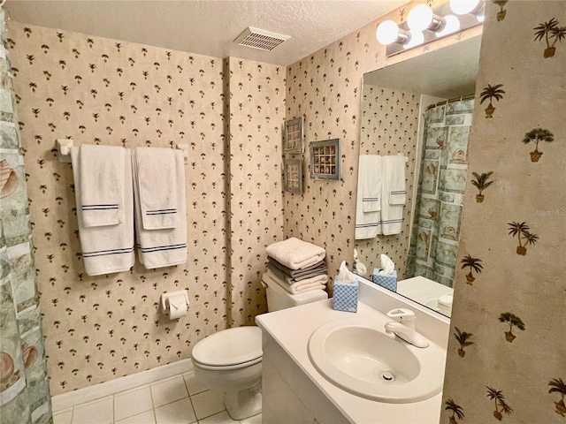 bathroom with curtained shower, tile patterned flooring, vanity, toilet, and a textured ceiling