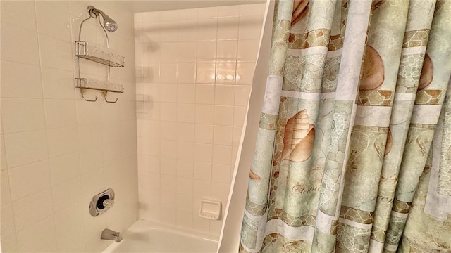 bathroom with shower / bath combo with shower curtain