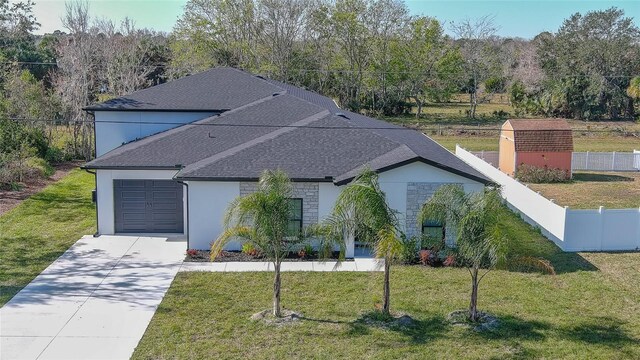 view of front of home with a front yard and a garage