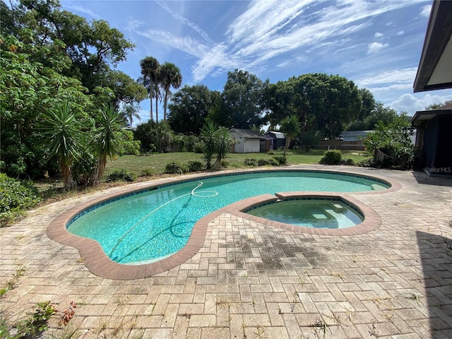 view of pool featuring a patio and an in ground hot tub