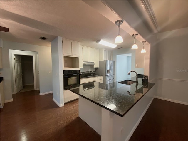 kitchen with black appliances, white cabinetry, kitchen peninsula, and decorative light fixtures