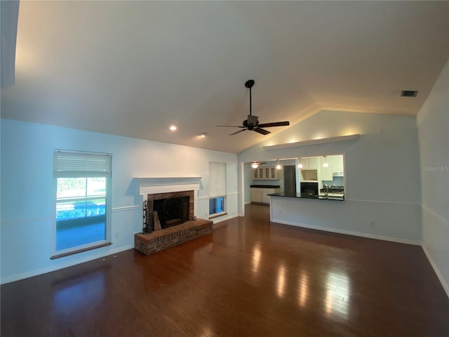 unfurnished living room featuring vaulted ceiling, a fireplace, dark hardwood / wood-style flooring, ceiling fan, and sink