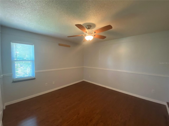 spare room featuring ceiling fan, a textured ceiling, and dark hardwood / wood-style flooring