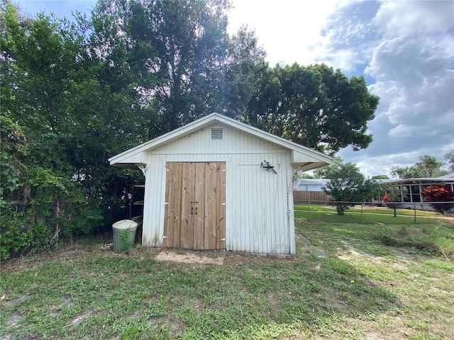 view of outdoor structure featuring a lawn