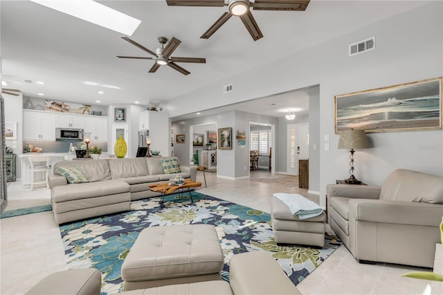 tiled living room with ceiling fan