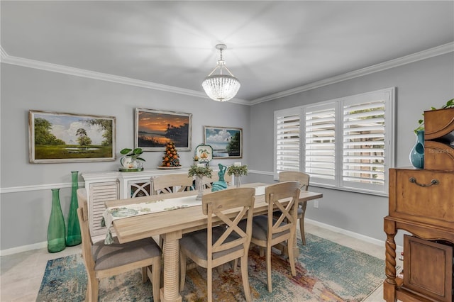 dining room with a chandelier and crown molding