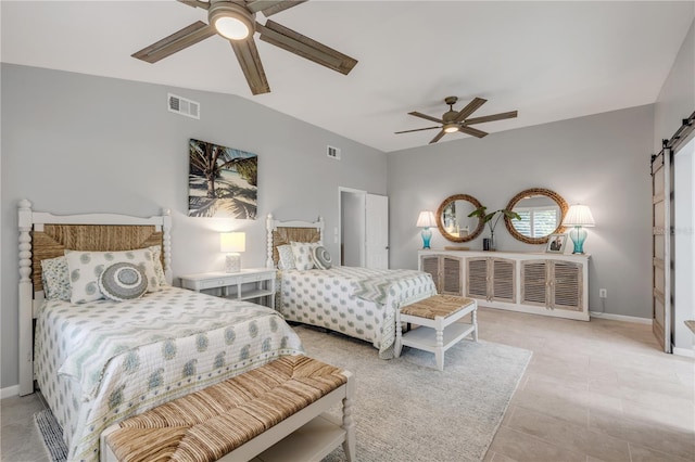 bedroom with a barn door, light tile patterned floors, vaulted ceiling, and ceiling fan