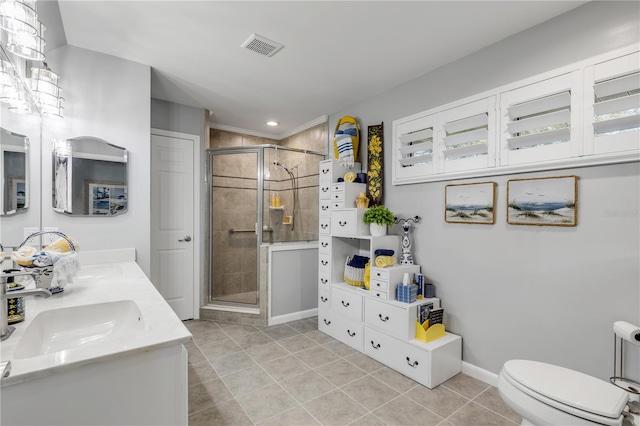 bathroom featuring tile patterned flooring, a shower with door, toilet, and vanity