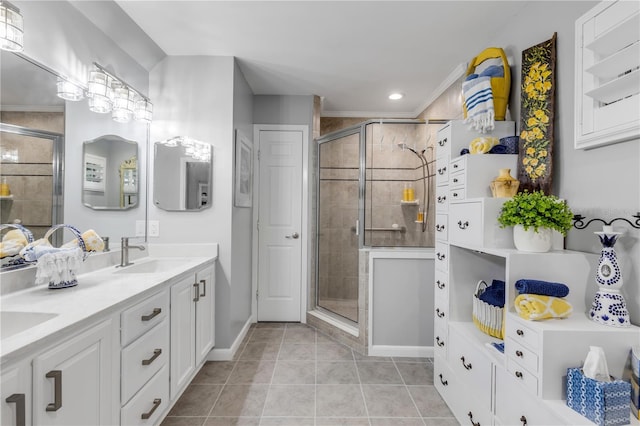 bathroom featuring walk in shower, vanity, and tile patterned floors