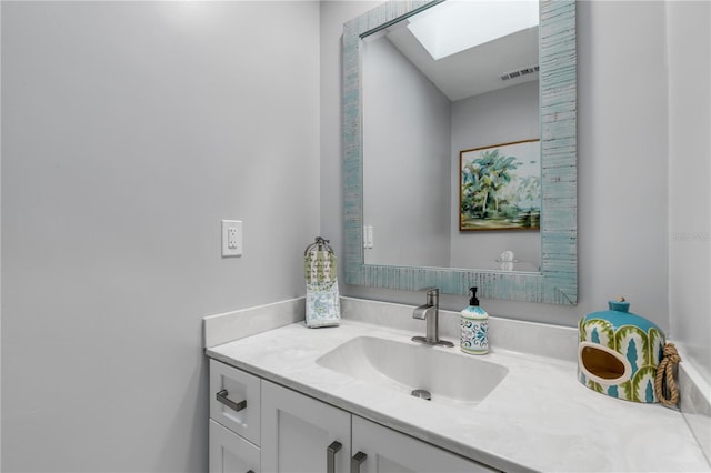 bathroom with vanity and a skylight