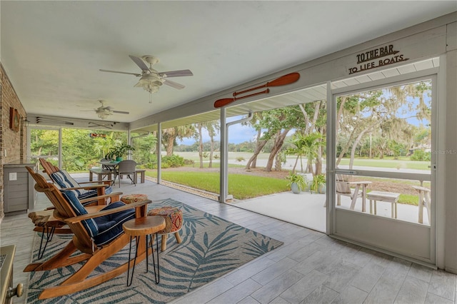 sunroom with a wealth of natural light and ceiling fan