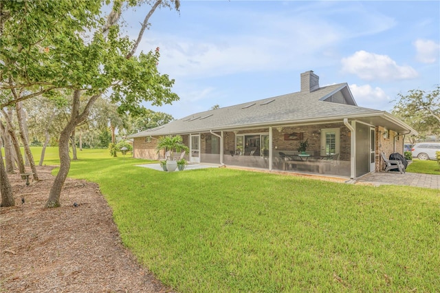 back of property featuring a patio area and a yard