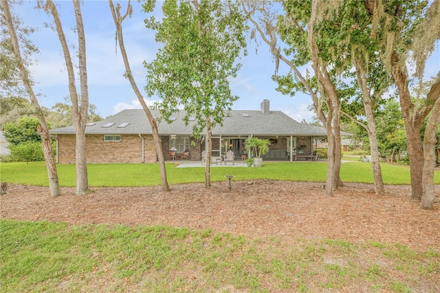 view of yard featuring a sunroom and a patio