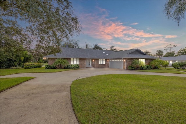 ranch-style house with a lawn and a garage