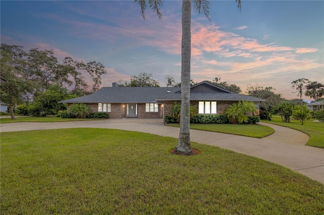 ranch-style house with a yard