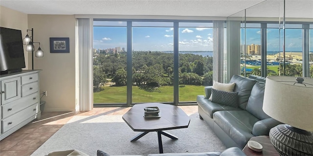 tiled living room with floor to ceiling windows and a textured ceiling