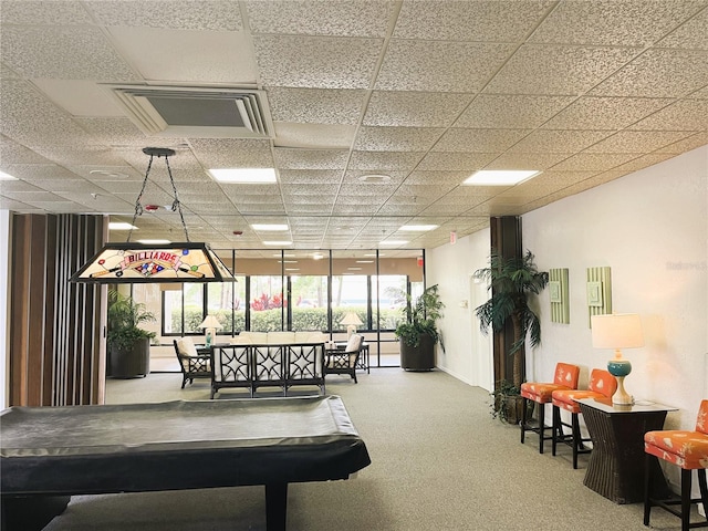 interior space featuring a drop ceiling, plenty of natural light, and carpet flooring