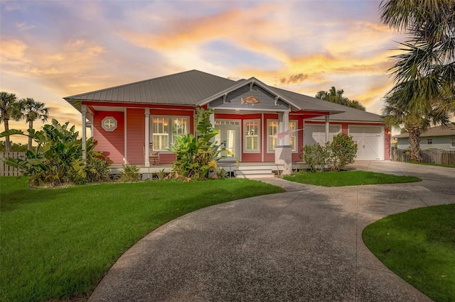 view of front facade with a lawn and a garage