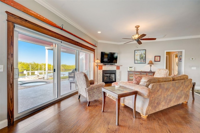 living room with ornamental molding, ceiling fan, and hardwood / wood-style flooring