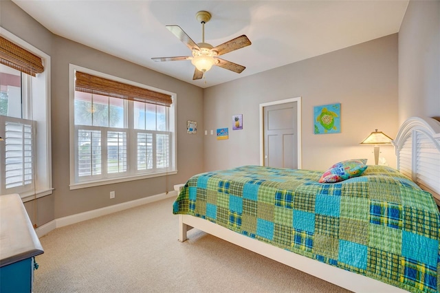 bedroom with ceiling fan, carpet, and multiple windows