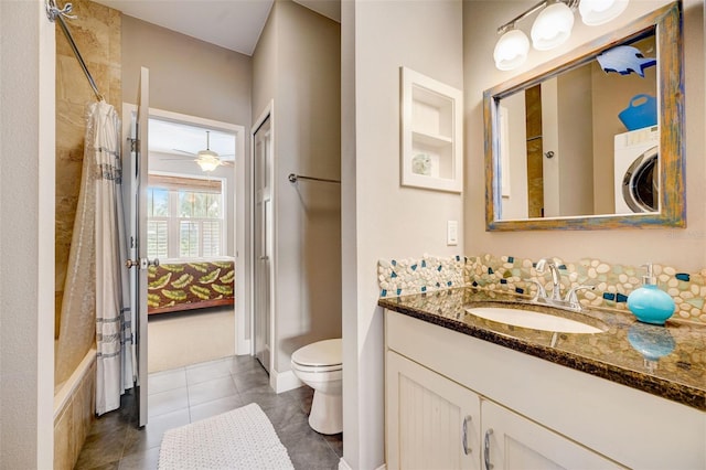 full bathroom featuring vanity, washer / clothes dryer, tile patterned floors, toilet, and shower / tub combo with curtain