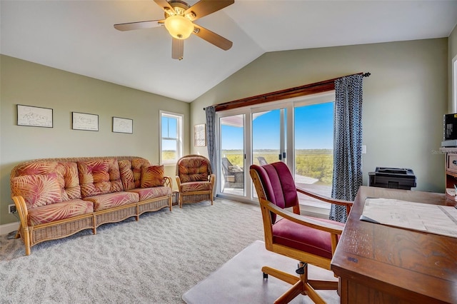 home office with carpet, ceiling fan, and vaulted ceiling