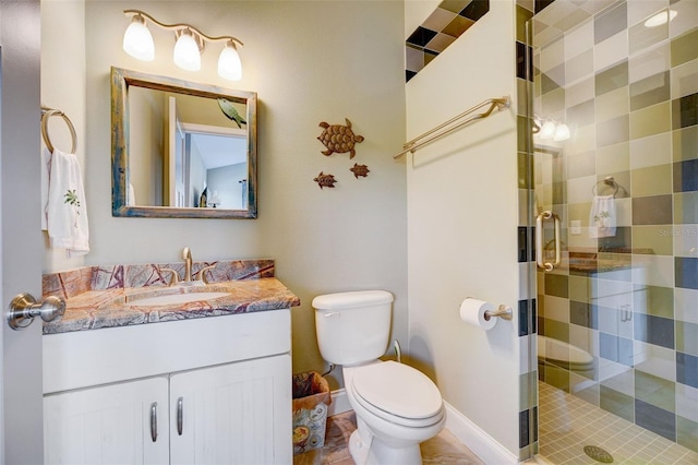 bathroom with vanity, toilet, tile patterned floors, and a shower with shower door