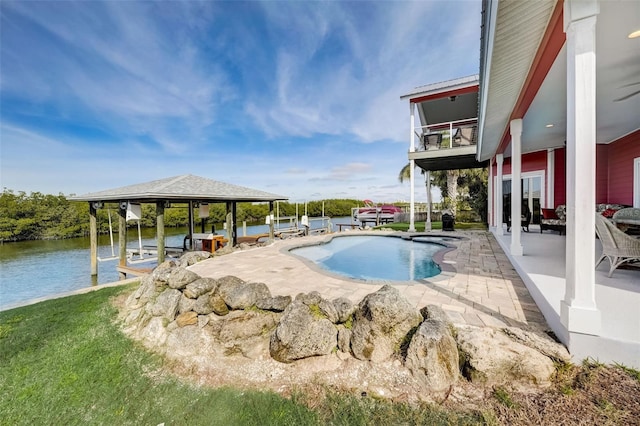 view of swimming pool with a water view, a patio area, and french doors