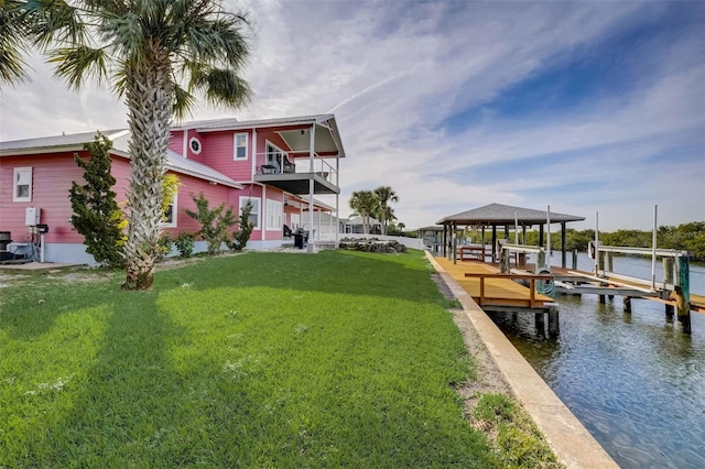 dock area featuring a lawn and a water view