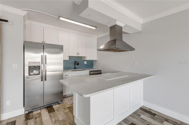 kitchen featuring appliances with stainless steel finishes, light hardwood / wood-style floors, white cabinetry, range hood, and sink