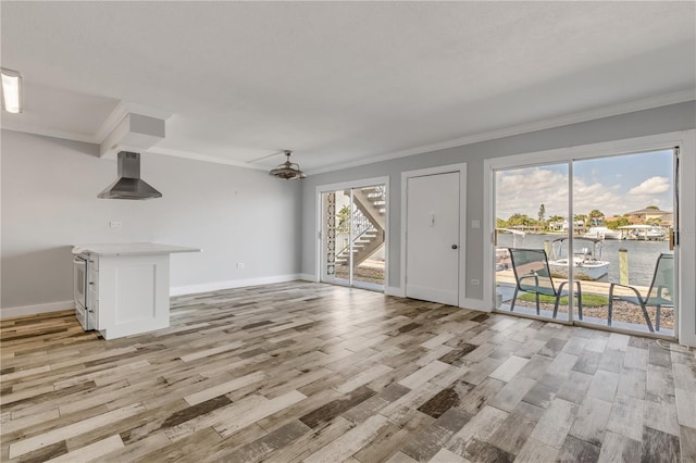 living room featuring light wood-type flooring, crown molding, and a water view