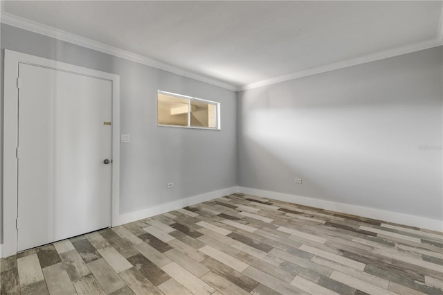 spare room with light hardwood / wood-style floors and ornamental molding