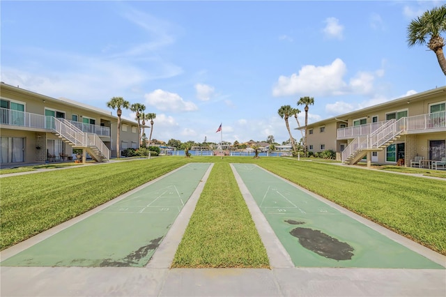 view of property's community featuring a lawn