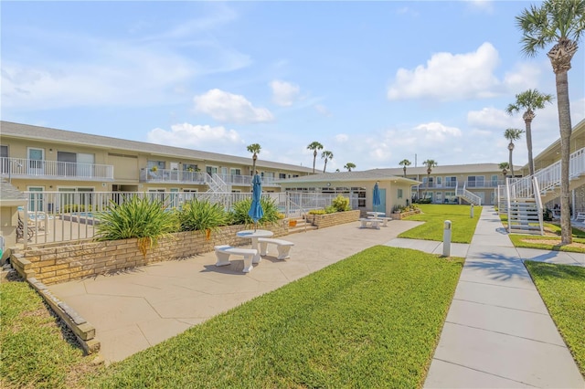 surrounding community featuring a patio area and a yard