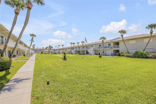 view of home's community featuring a lawn