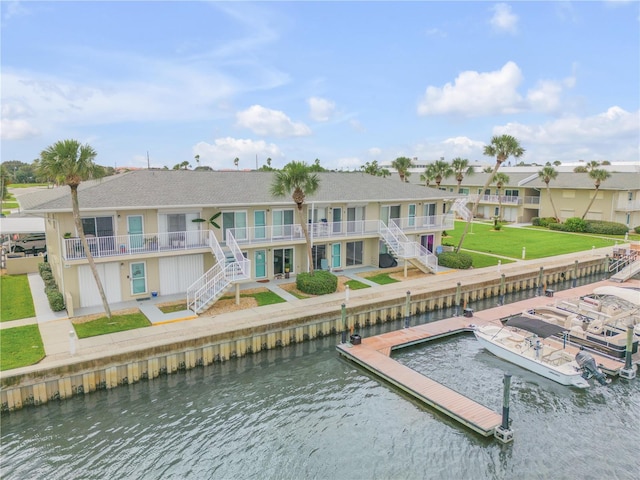 back of house with a balcony and a water view