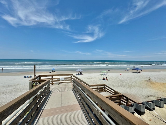 surrounding community with a water view and a view of the beach