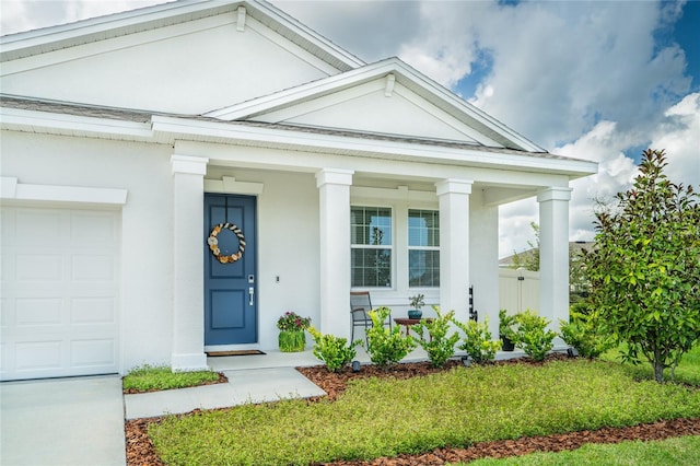 entrance to property with a porch and a garage