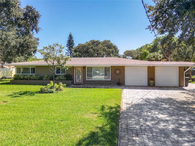 single story home with a front lawn and a garage